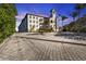 Exterior view of condo building at sunset, showing landscaping and parking at 900 E Marion Ave # 1301, Punta Gorda, FL 33950