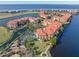 Aerial view of waterfront community with resort-style pool and tennis courts at 98 Vivante Blvd # 98317, Punta Gorda, FL 33950