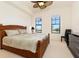 Relaxing bedroom with a wooden bed frame and large windows at 98 Vivante Blvd # 98317, Punta Gorda, FL 33950