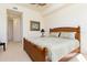 King-size bedroom with wood furniture and ceiling fan at 98 Vivante Blvd # 98317, Punta Gorda, FL 33950