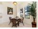 Bright breakfast nook with glass table and wicker chairs, offering water views at 98 Vivante Blvd # 98317, Punta Gorda, FL 33950