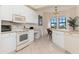 White kitchen with island and built-in microwave at 98 Vivante Blvd # 98317, Punta Gorda, FL 33950