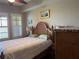 Spacious bedroom with large bed and wood accents at 99 Vivante Blvd # 415, Punta Gorda, FL 33950