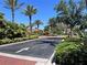 Residential entrance with palm trees and landscaped medians at 99 Vivante Blvd # 415, Punta Gorda, FL 33950