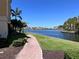 Tranquil lakefront walkway with lush landscaping at 99 Vivante Blvd # 415, Punta Gorda, FL 33950