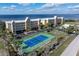 Aerial view of waterfront community with tennis court and pool at 101 N Marion Ct # 114, Punta Gorda, FL 33950