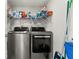 Laundry room with washer, dryer, and storage shelves at 101 N Marion Ct # 114, Punta Gorda, FL 33950