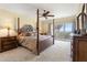 Main bedroom with a post bed and ocean view at 101 N Marion Ct # 114, Punta Gorda, FL 33950