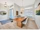 Elegant dining room with a rustic wood table and chandelier at 1023 San Mateo Dr, Punta Gorda, FL 33950