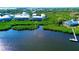 Aerial view of waterfront home nestled in tropical landscape at 10320 Lands End Cir # 47, Placida, FL 33946