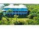 Aerial view of a teal building with a large backyard at 10320 Lands End Cir # 47, Placida, FL 33946