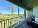 Screened balcony boasting relaxing rocking chairs and scenic nature views at 10320 Lands End Cir # 47, Placida, FL 33946