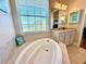 Bathroom with soaking tub and lake view at 10320 Lands End Cir # 47, Placida, FL 33946