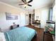 Spacious bedroom with a queen bed, wood floors, and a beach-themed wall art at 10320 Lands End Cir # 47, Placida, FL 33946