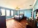 Primary bedroom with a king-size bed and blue walls at 10320 Lands End Cir # 47, Placida, FL 33946