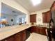 Well-equipped clubhouse kitchen with dark wood cabinets at 10320 Lands End Cir # 47, Placida, FL 33946