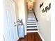 Modern white and wood staircase leading to the upper level at 10320 Lands End Cir # 47, Placida, FL 33946