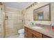 Bathroom with granite vanity and tiled shower at 109 Peckham Se St, Port Charlotte, FL 33952