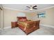 Bright bedroom with wood bed frame and ceiling fan at 109 Peckham Se St, Port Charlotte, FL 33952