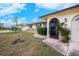 House exterior featuring a landscaped yard and screened entryway at 109 Peckham Se St, Port Charlotte, FL 33952