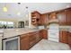 Kitchen features granite counters, wood cabinets, and wine cooler at 109 Peckham Se St, Port Charlotte, FL 33952