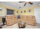 Living room with sectional sofa and large windows at 109 Peckham Se St, Port Charlotte, FL 33952