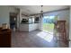 Dining area with tile floor, view of backyard and kitchen at 12143 & 12151 Dubarry Ave, Port Charlotte, FL 33981