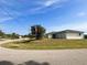 Single-story home with light-colored walls and a dark roof, situated on a grassy lot at 12143 & 12151 Dubarry Ave, Port Charlotte, FL 33981