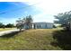 Single-story home with a large front yard and driveway at 12143 & 12151 Dubarry Ave, Port Charlotte, FL 33981