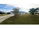 House exterior with a driveway and landscaping at 12143 & 12151 Dubarry Ave, Port Charlotte, FL 33981