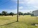 Large grassy lot with some small trees at 12143 & 12151 Dubarry Ave, Port Charlotte, FL 33981