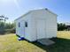 White metal storage shed with a ramp and windows at 12143 & 12151 Dubarry Ave, Port Charlotte, FL 33981