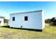 Rear view of a white metal storage shed at 12143 & 12151 Dubarry Ave, Port Charlotte, FL 33981