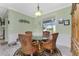 Bright dining area with glass-top table, four chairs, and a hutch at 13204 Kakapo Ave, Port Charlotte, FL 33981