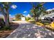 Paved driveway with landscaping and a view of the house and garage at 13204 Kakapo Ave, Port Charlotte, FL 33981