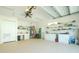 Spacious garage with cabinets, shelving, and workshop area at 13204 Kakapo Ave, Port Charlotte, FL 33981