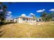 Front yard view of a charming yellow house with a metal roof and porch at 13204 Kakapo Ave, Port Charlotte, FL 33981