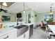 Kitchen with white cabinets, a farmhouse sink, and stainless steel appliances at 13204 Kakapo Ave, Port Charlotte, FL 33981