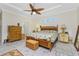 Main bedroom with king bed, ceiling fan, and wooden furniture at 13204 Kakapo Ave, Port Charlotte, FL 33981