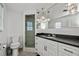 Bathroom with a walk-in shower, dark countertop, and modern lighting at 1350 Aqua View Ln, Englewood, FL 34223