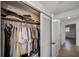 Well-organized closet with hanging clothes and shelves at 1350 Aqua View Ln, Englewood, FL 34223