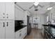 Modern kitchen with white cabinets and black countertops at 1350 Aqua View Ln, Englewood, FL 34223