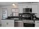 Kitchen features stainless steel appliances and a view of the pool at 1350 Aqua View Ln, Englewood, FL 34223