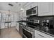 Modern kitchen with stainless steel appliances and dark countertops at 1350 Aqua View Ln, Englewood, FL 34223