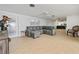 Spacious living room with gray sectional sofa and tile flooring at 1350 Aqua View Ln, Englewood, FL 34223