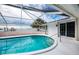 Stunning waterfront pool with screened enclosure at 1350 Aqua View Ln, Englewood, FL 34223