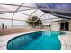 Inviting pool area with screened enclosure, offering waterfront views at 1350 Aqua View Ln, Englewood, FL 34223