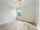 Bright bedroom with wood-look tile flooring and a large window at 13707 Begonia Cir, Port Charlotte, FL 33981