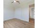 Bright bedroom with wood-look tile flooring and ceiling fan at 13707 Begonia Cir, Port Charlotte, FL 33981