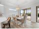 Spacious dining area with a farmhouse table and sliding glass doors leading outside at 13707 Begonia Cir, Port Charlotte, FL 33981